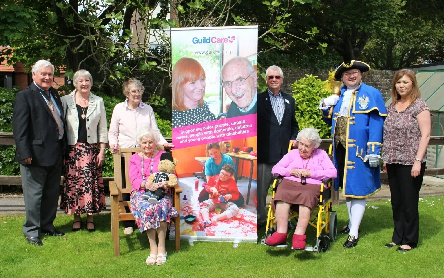 Bob Smytherman in full blue and gold regalia alongside Guild Care staff and residents at a charity fundraising day in Worthing.